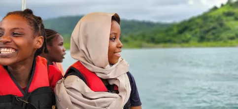 jeune fille de profil avec en fond un paysage d'océan et d'ile 