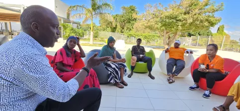 Un homme explique a un groupe de jeunes les principes d'un hotel.